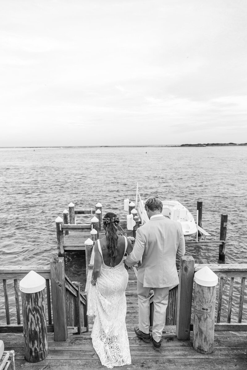 couple walking onto a dock