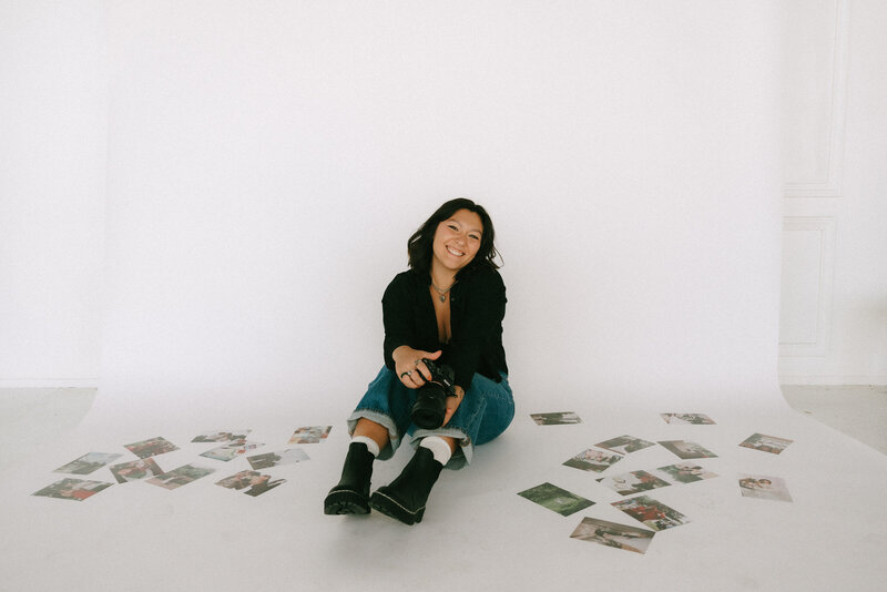 young super 8 film photographer, destination wedding photographer sitting on ground, surrounded by wedding photographs