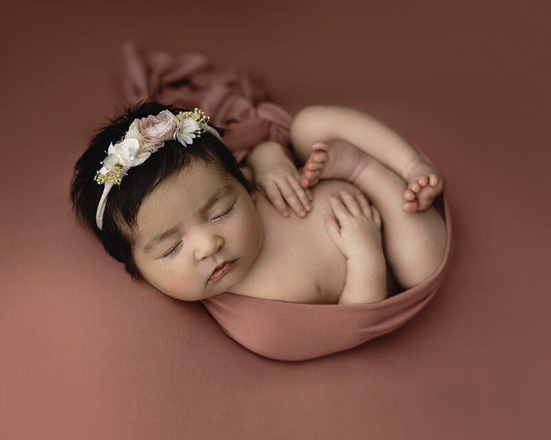 Newborn baby girl in pink Medford newborn photographer