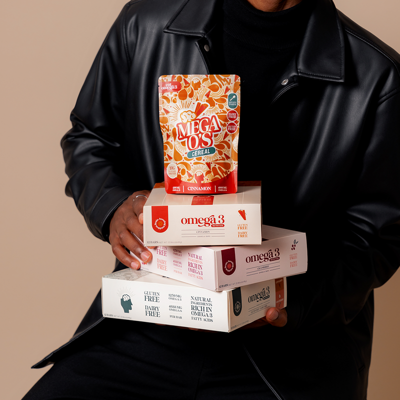 Man holding a stack of granola bars and cereal products