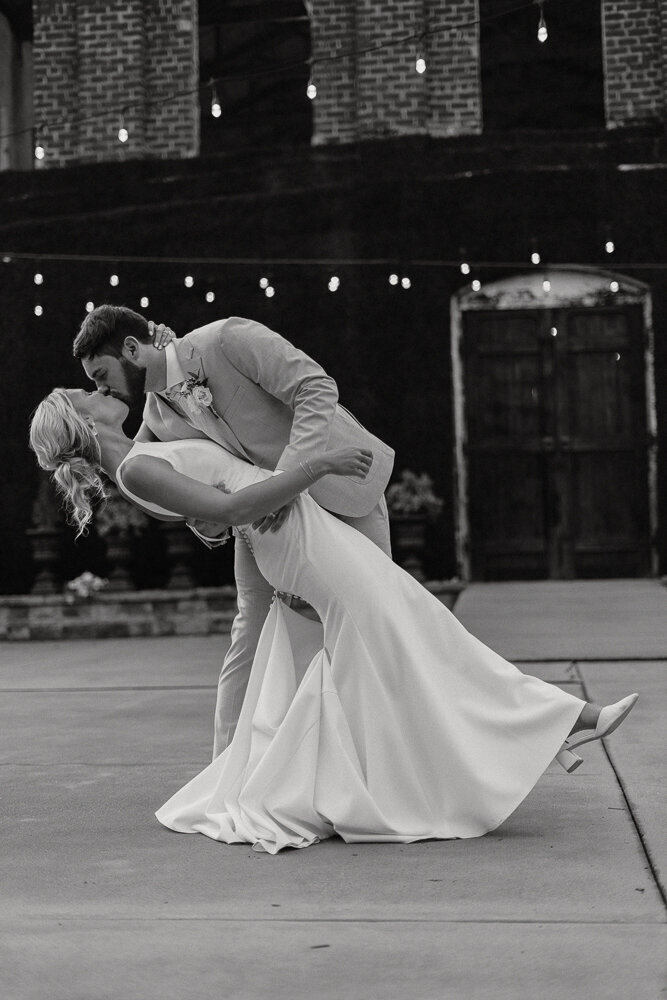 bride and groom doing a dip kiss