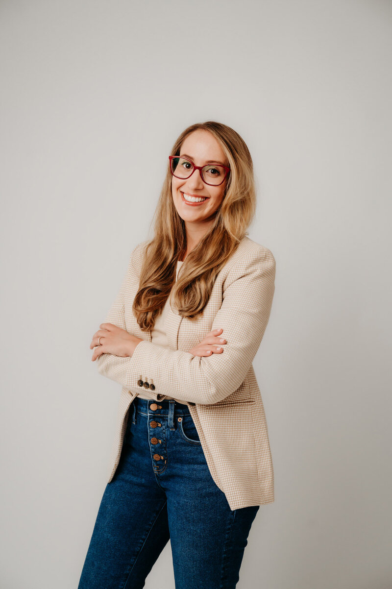Rachel Toner, food scientist and owner of Taste Strategy, standing and wearing nude blazer and blue jeans