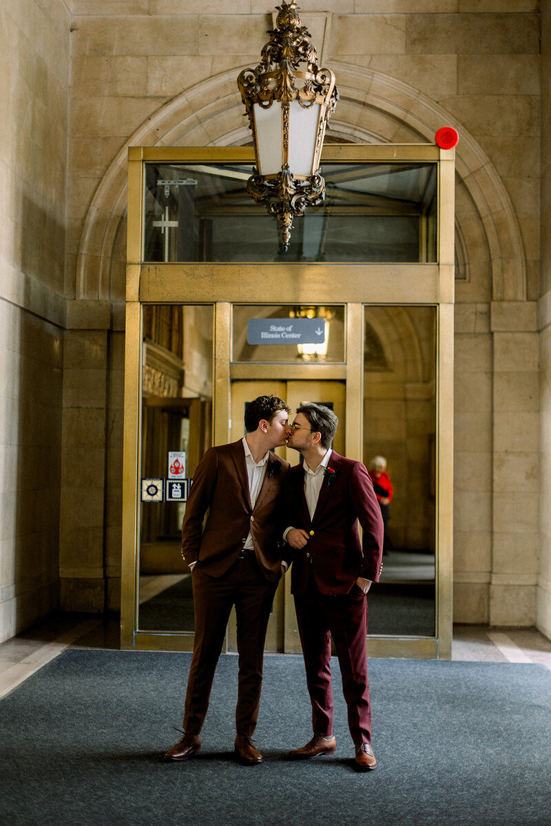 portrait of two grooms in a hallway
