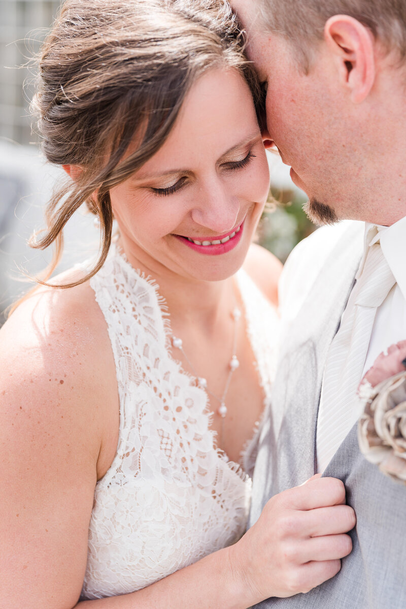 bride and groom snuggles during wedding photos