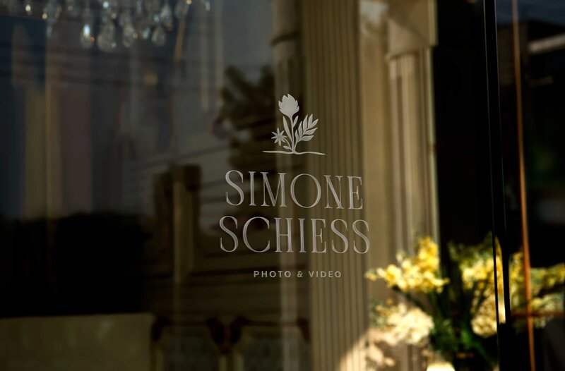 Simone's logo on glass