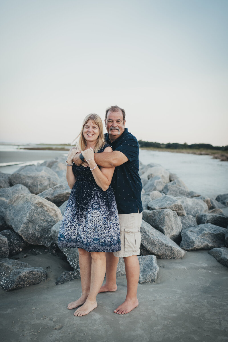 man and woman on the beach for family portraits at fripp island