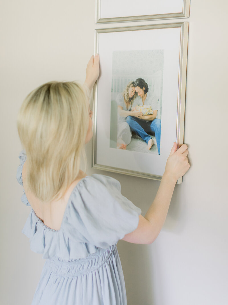 Photographer hanging custom gallery wall design