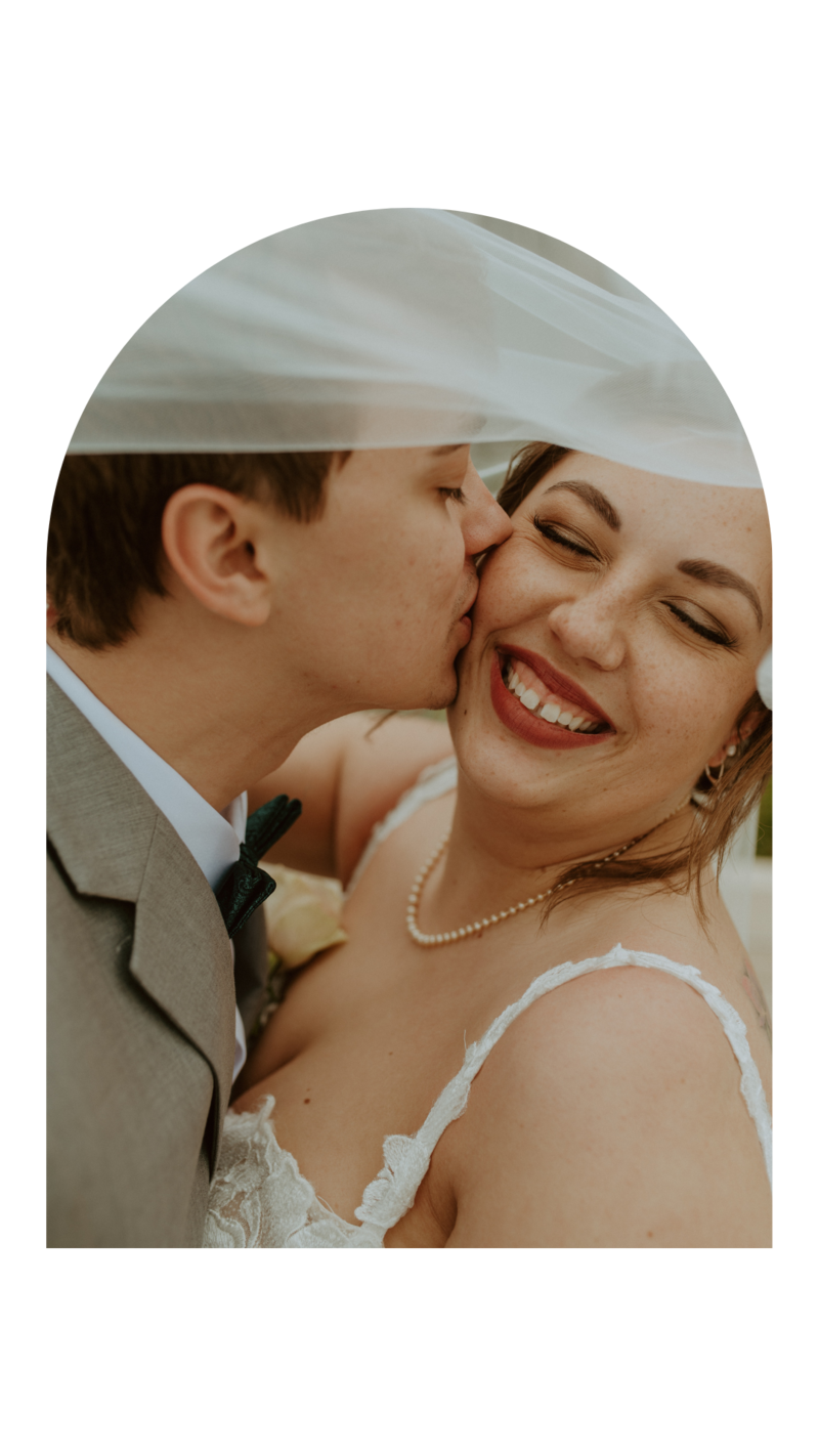 Man and woman smiling and looking at each other on wedding day