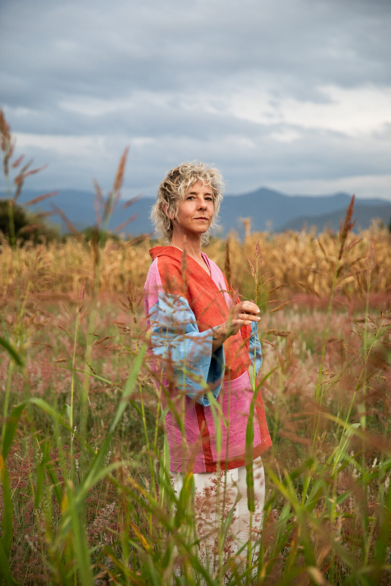 Portrait of Sasha standing in grassy field