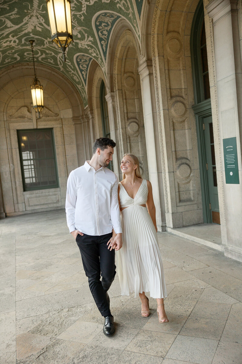 Bride and groom walking hand in hand at their Madison wedding venue.