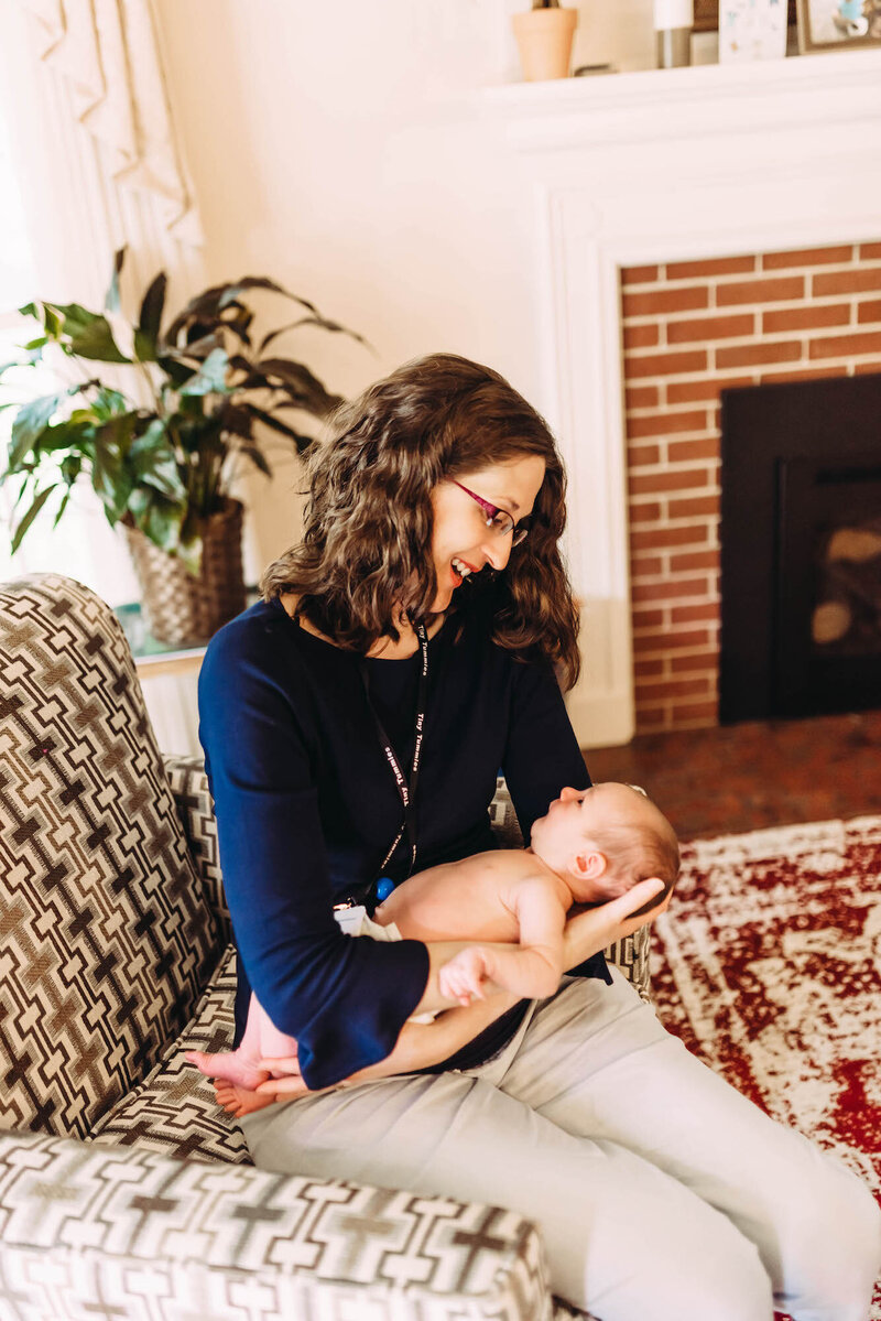 Woman sitting and holding a baby in her lap