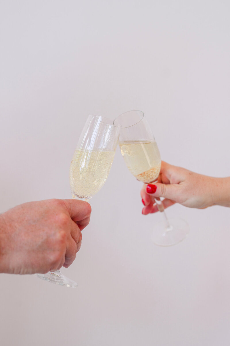 Close-up of a celebratory champagne toast, symbolizing joyful moments planned by a wedding planner in Austin for a relaxed and fun wedding day.