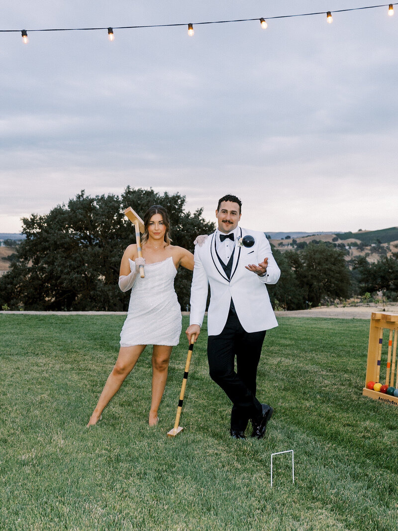 bride and groom during candid moment on their wedding day running through the vines