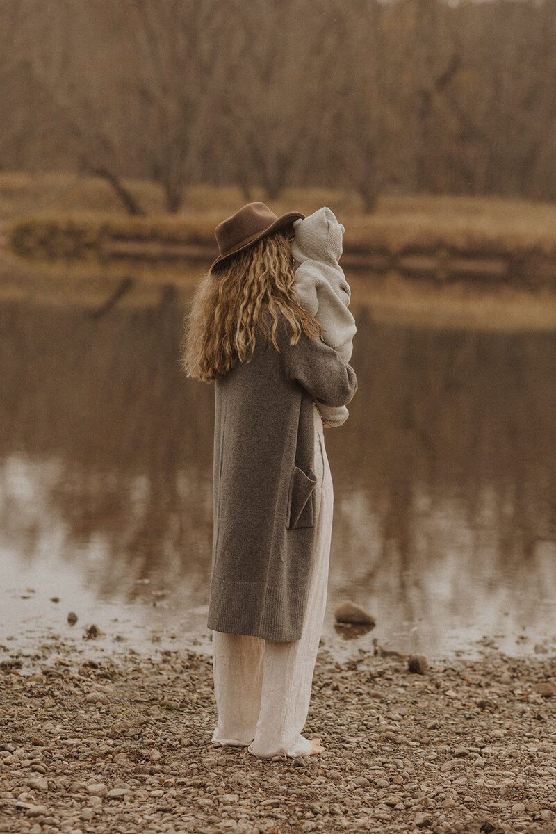 Minneapolis photographer shows her baby the water on the banks of St. Croix, Minnesota
