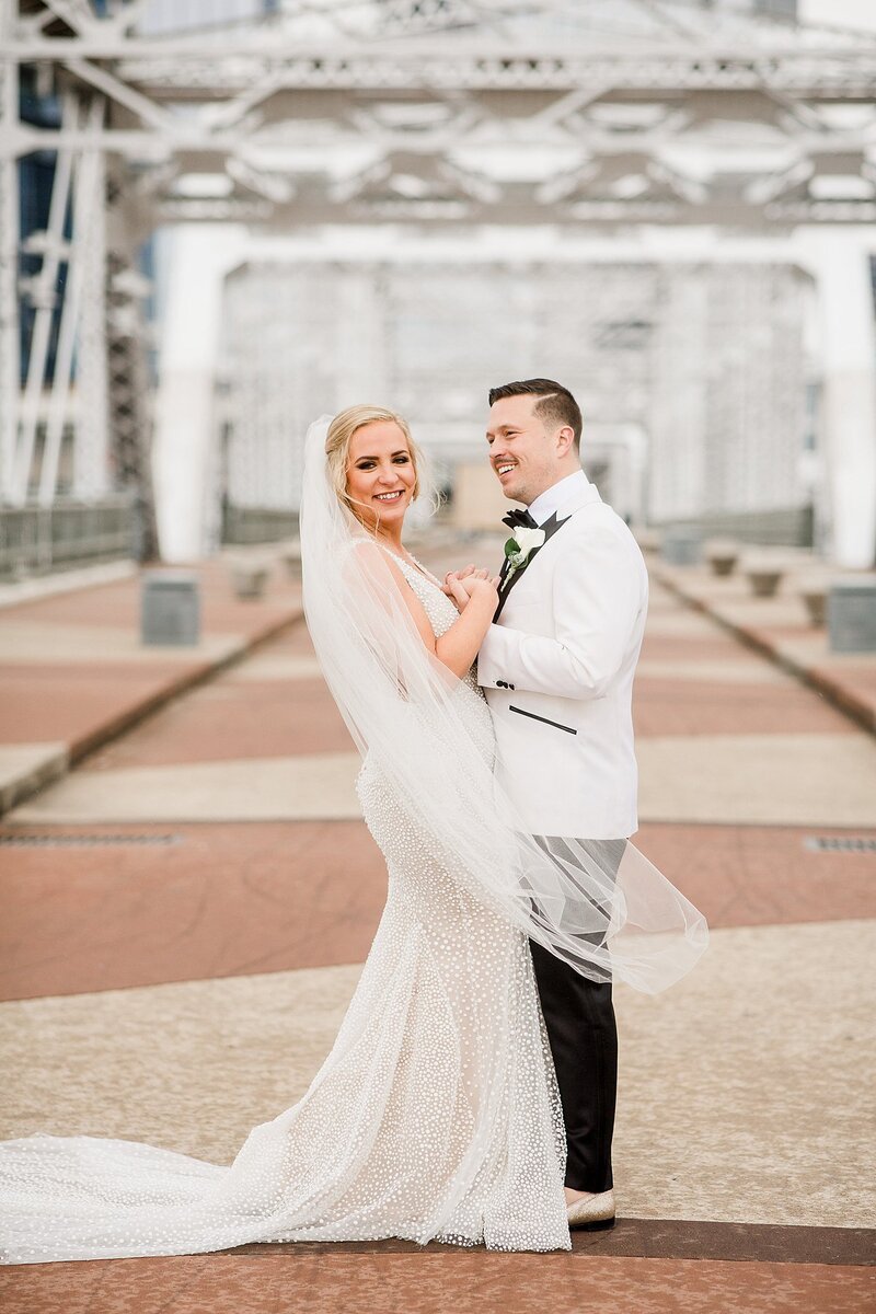 holding hands on a bridge by Knoxville Wedding Photographer, Amanda May Photos