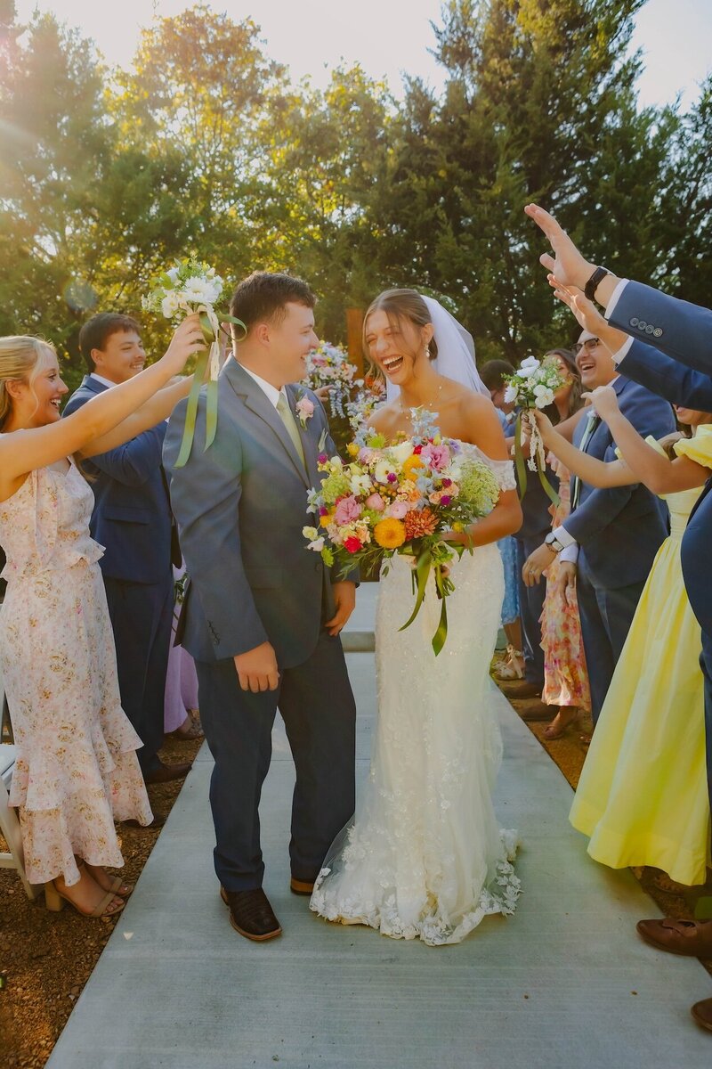 bride and groom celebrating with friends at wedding in dallas texas
