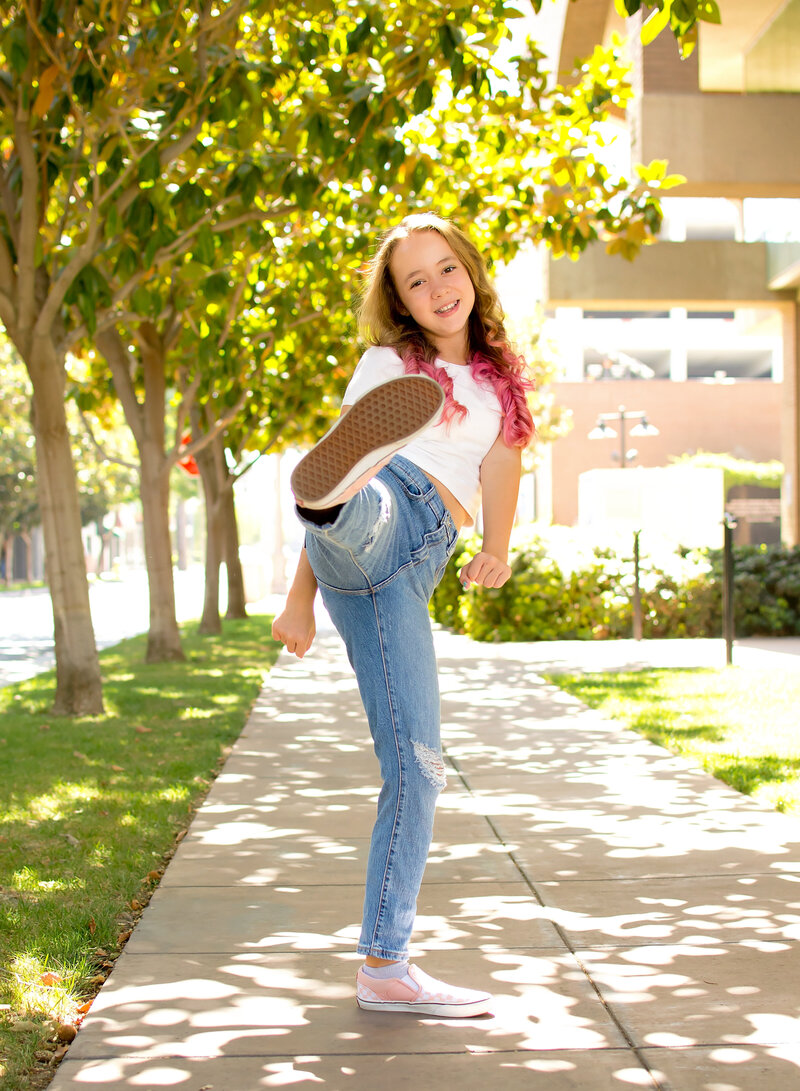 Girl kicking toward the camera in Downtown Riverside CA