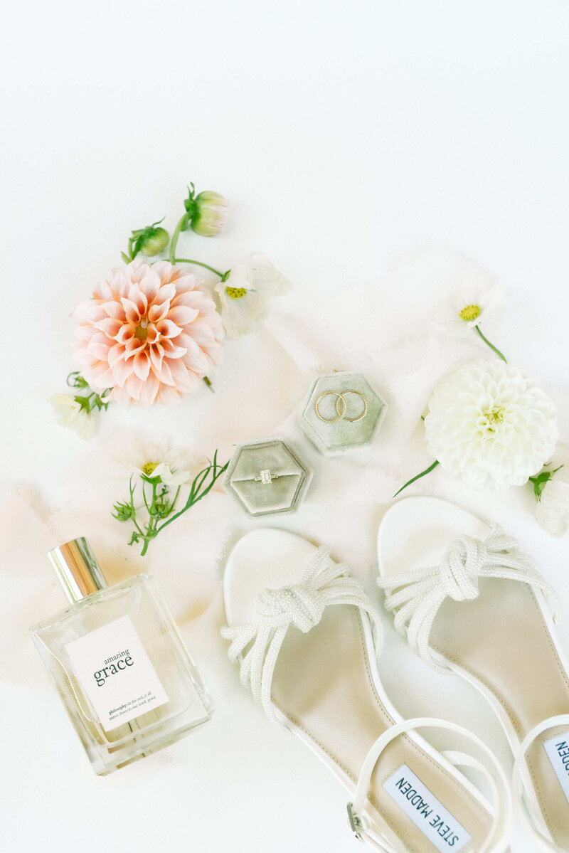 Bridal details with ring and shoes next to flowers