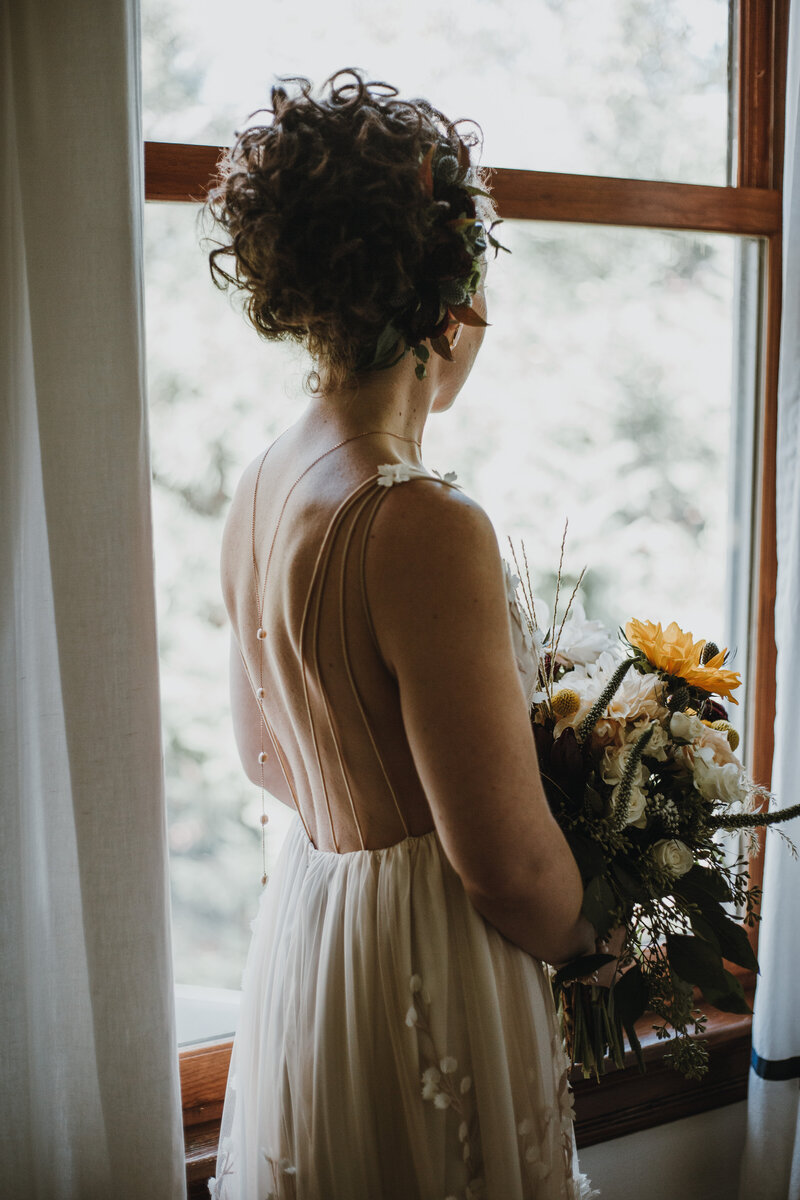 bride in white dress holding bouquet of flowers