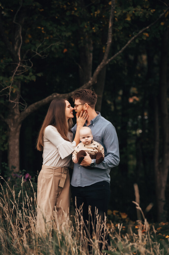 mom and dad in neutrals holding todler in beigh clothes