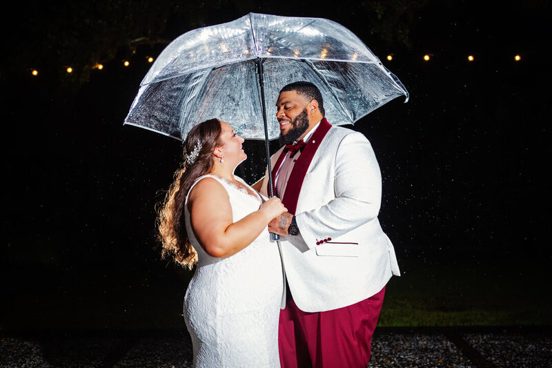 Kissing in the rain Charleston wedding photographer luxe by lindsay photography