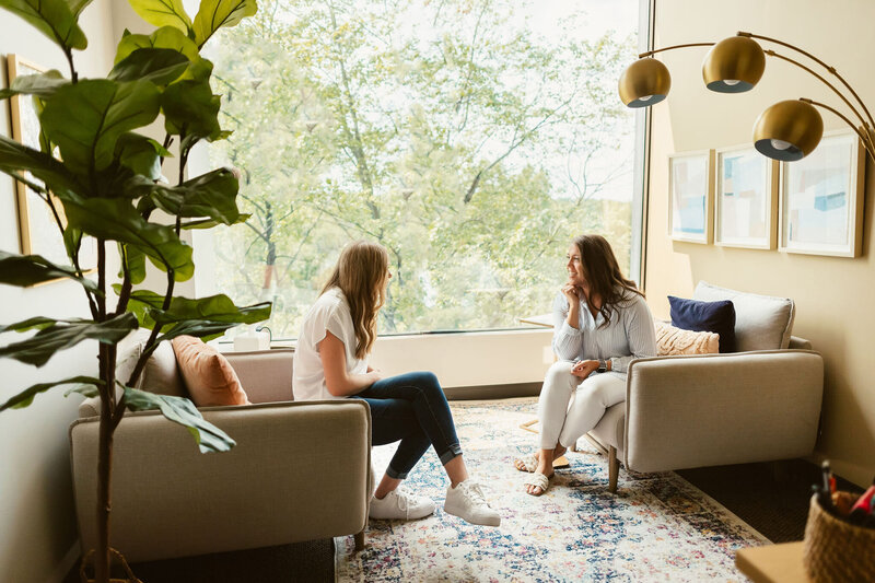 two women chatting in a therapy office