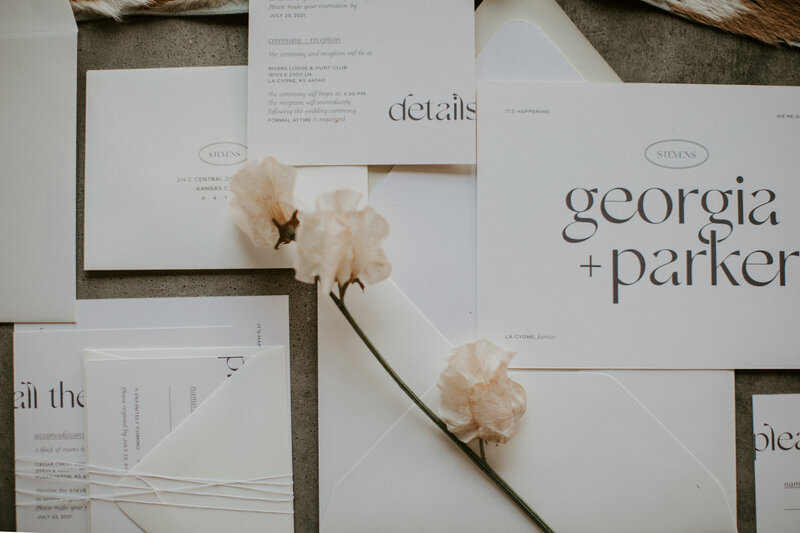 Custom designed wedding stationery with white paper and modern serif text
