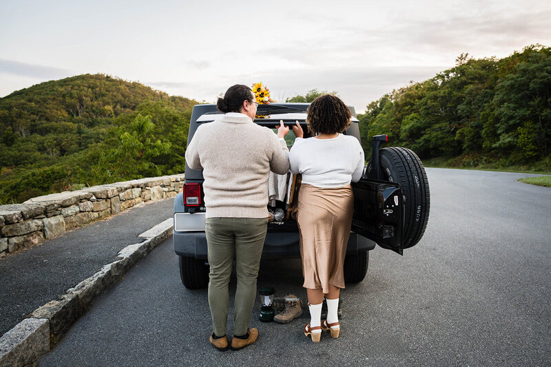 A couple opens the trunk of their Jeep during their Shenandoah National Park elopement wedding day.