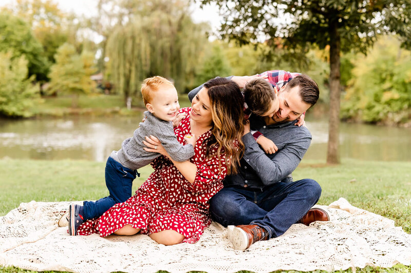 Family being silly on blanket during a family photography session near Naperville, IL.