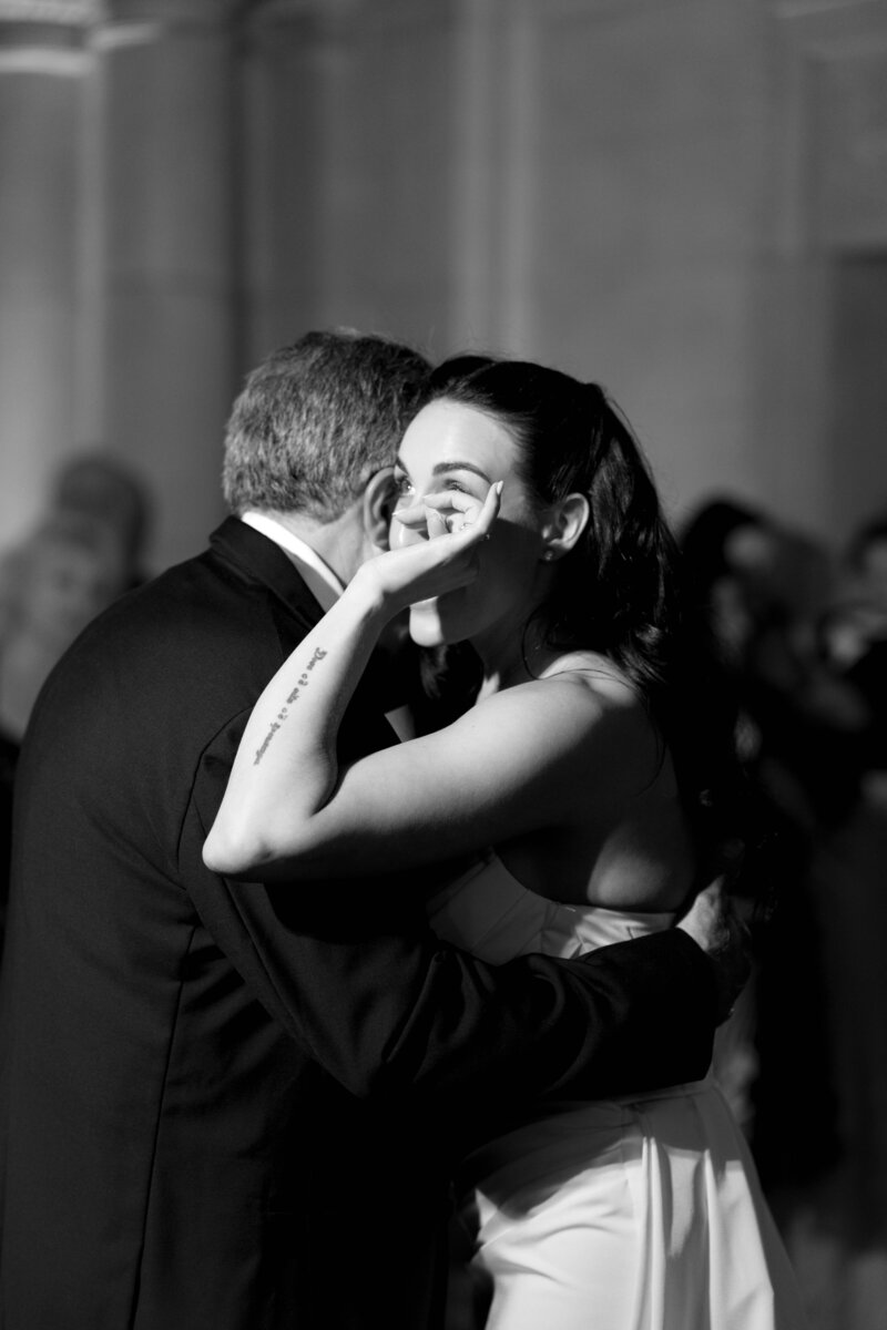 Bride dancing with father at wedding crying