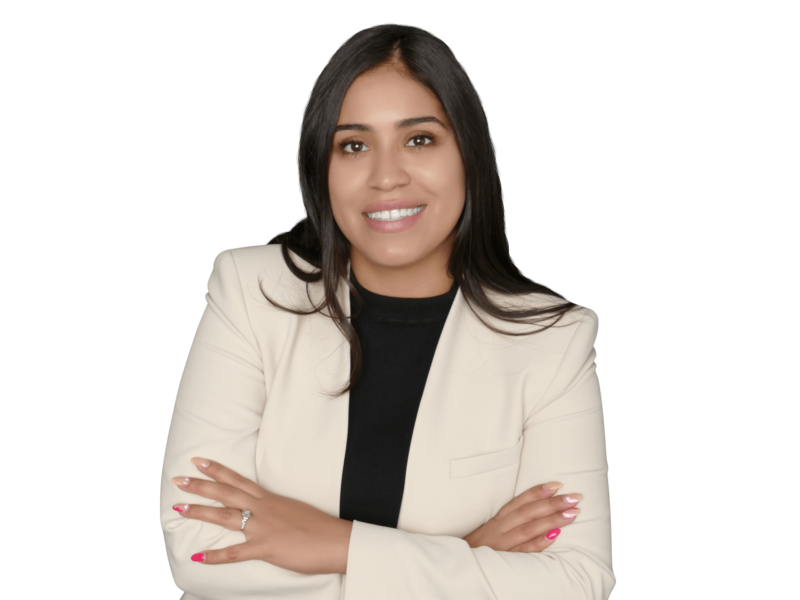 Female in black pants and a long sleeve black shirt standing with arms crossed