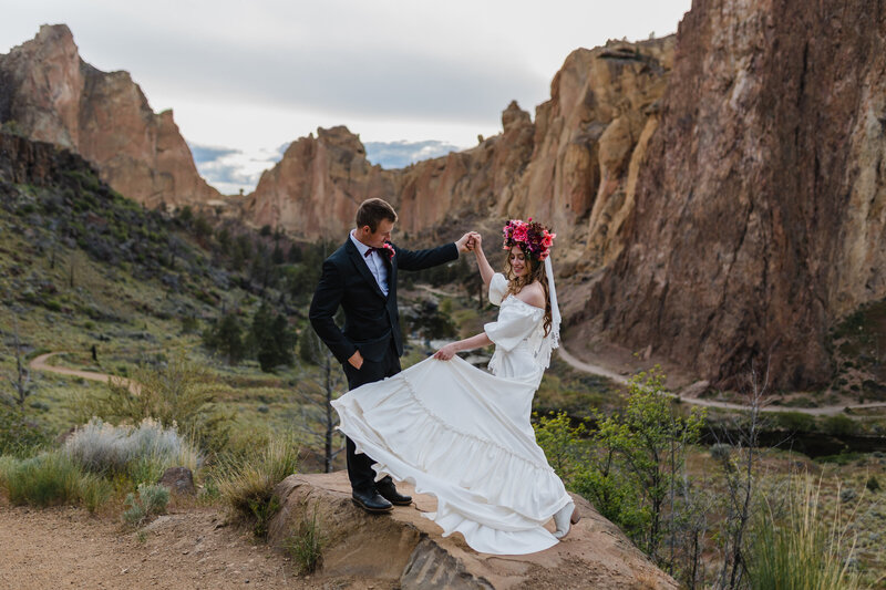 An adventurous couple embracing the raw beauty of the Pacific Northwest, surrounded by dramatic cliffs and natural landscapes.