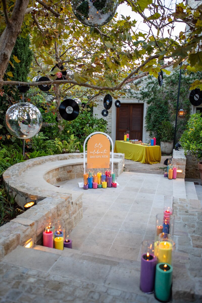 colorful retro birthday party decorated with hanging disco balls and records