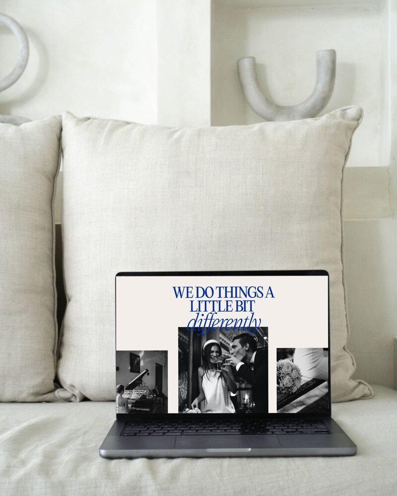 Mock Up of a photographers website on a laptop. Backdrop is a beige coach with some beige ornaments in the background.