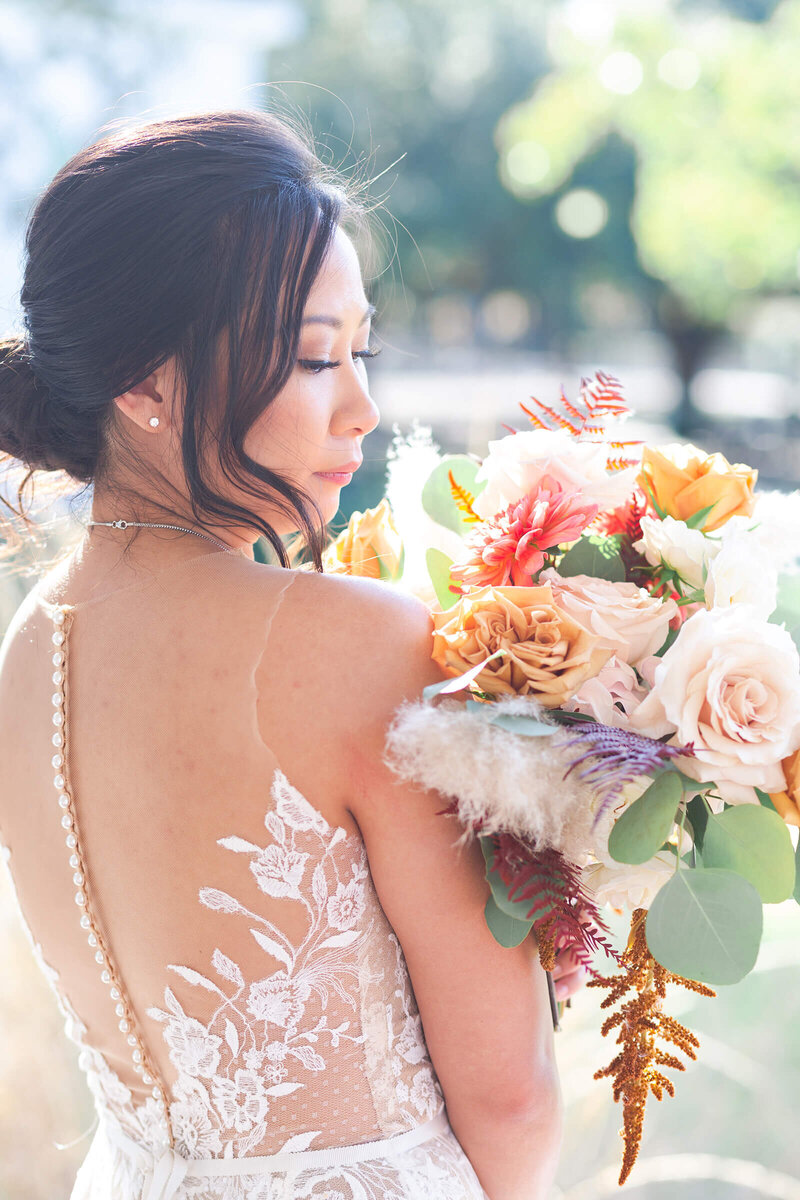 bride smells her bridal bouquet on her wedding day at Heritage Society in Houston by Swish and Click Photography