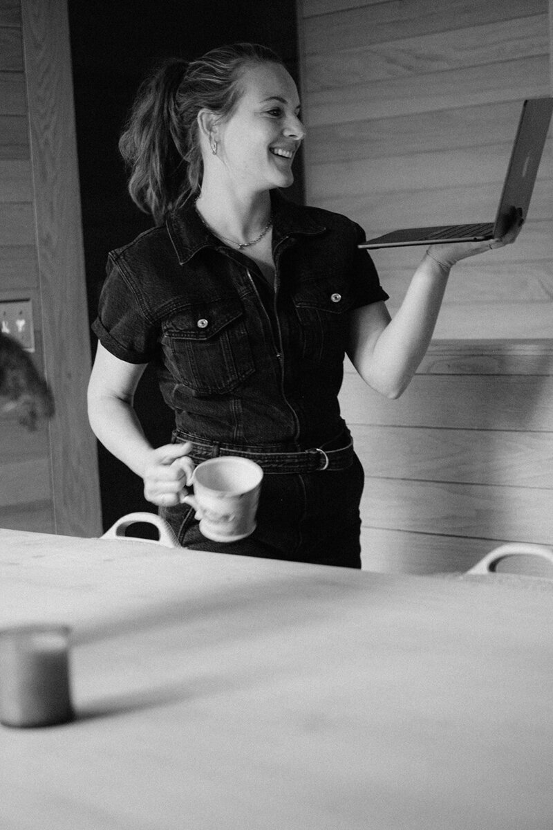 The founder of Echo and Ember holder her laptop