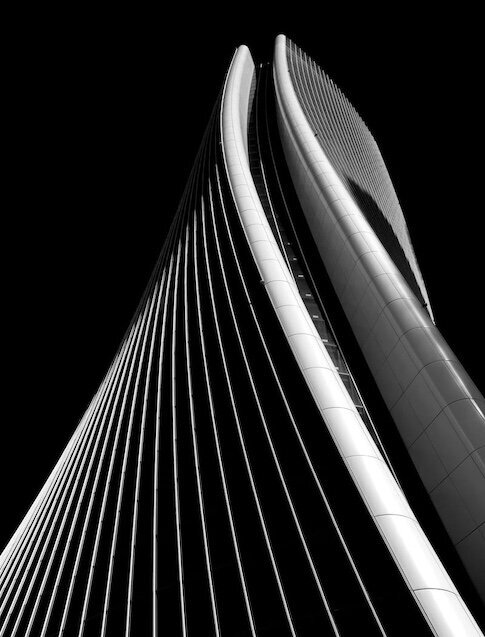 gray curved building with black background
