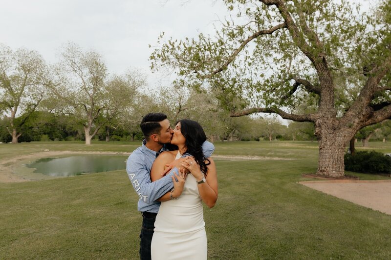 couple kisses during couples portraits in texas