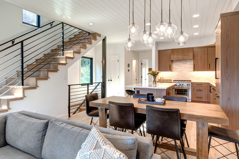Open floor living room and kitchen design by vacation home interior designer Chalet + Co.