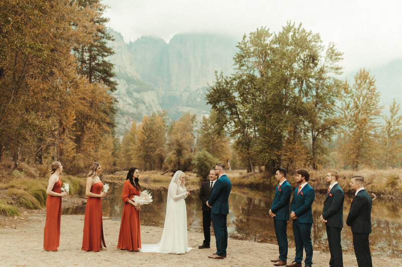elopement in Yosemite by a river with a mountain view