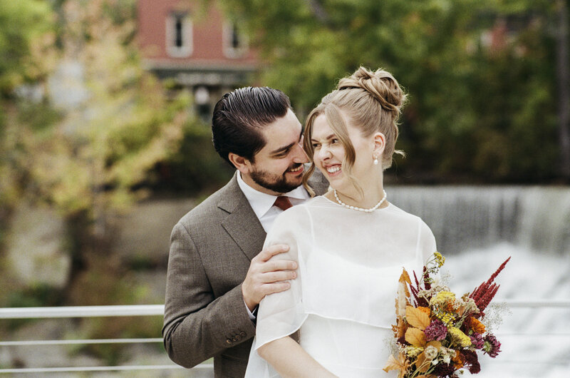 Fall wedding portrait of bride and groom at The Roundhouse in front of the waterfall in Beacon, NY shot on 35mm film