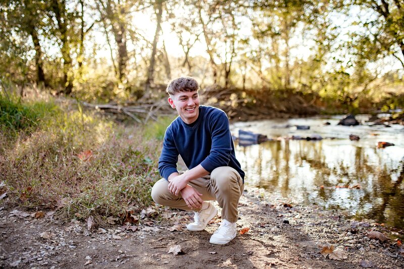 senior-guy-smiling-near-creek