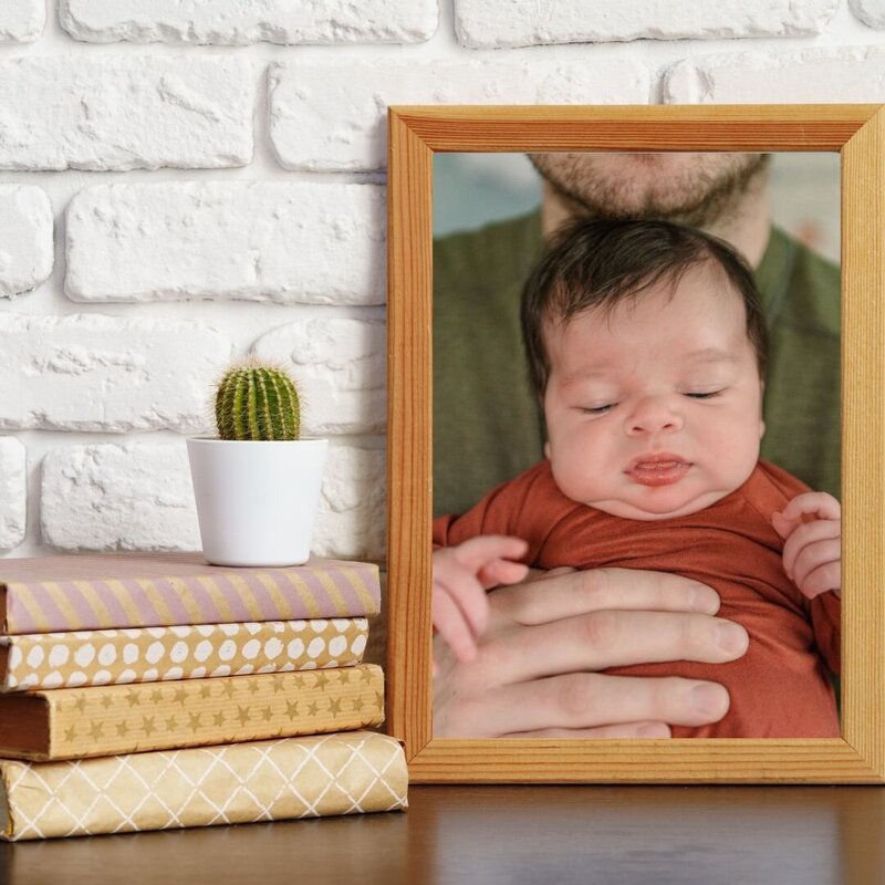 photo of father holding baby by newborn photography baltimore md