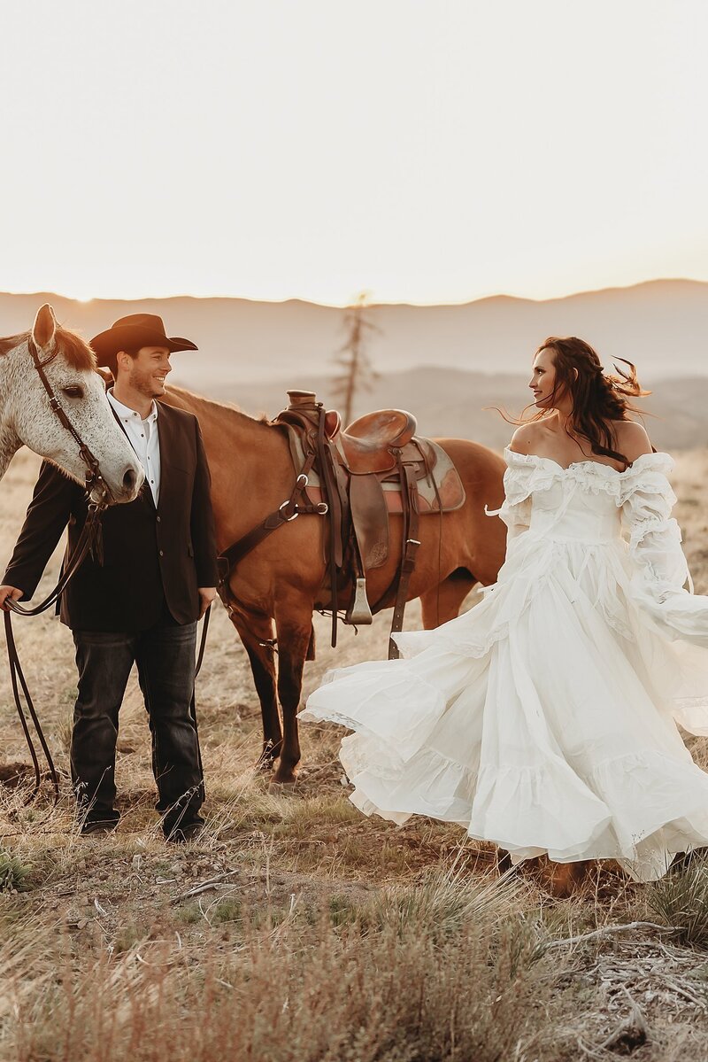 Bride and groom with horses in front of mountains in California during elopement