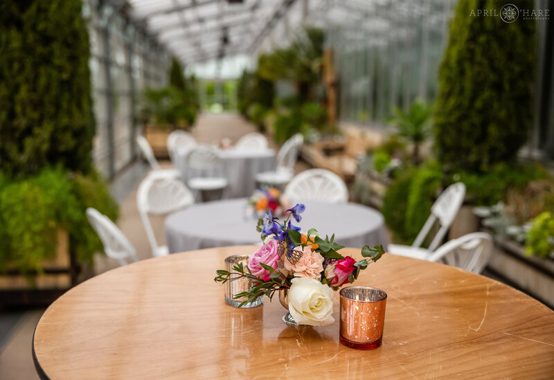 Tables set up inside the Orangery for a wedding at Denver Botanic Gardens