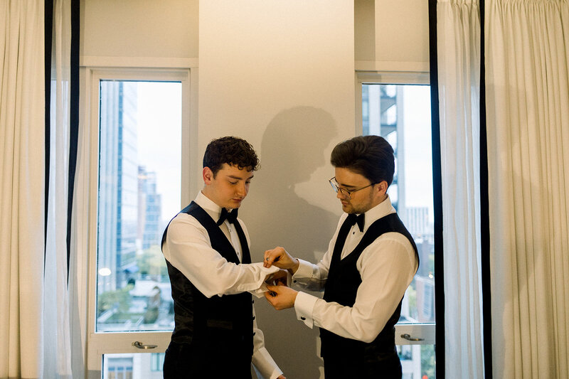 two grooms getting ready together