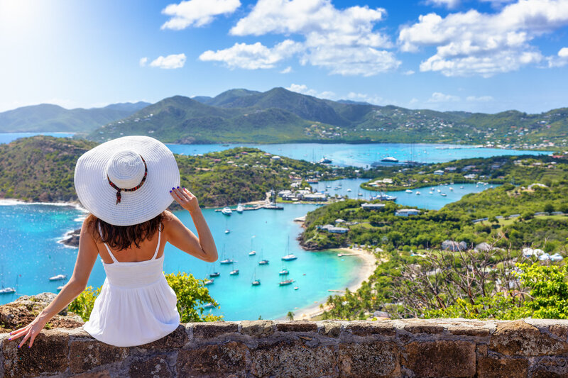 Woman overlooking a bay with sailboarts