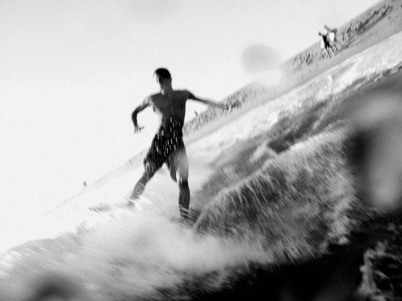 blurry action shot of skimboarder in the ocean