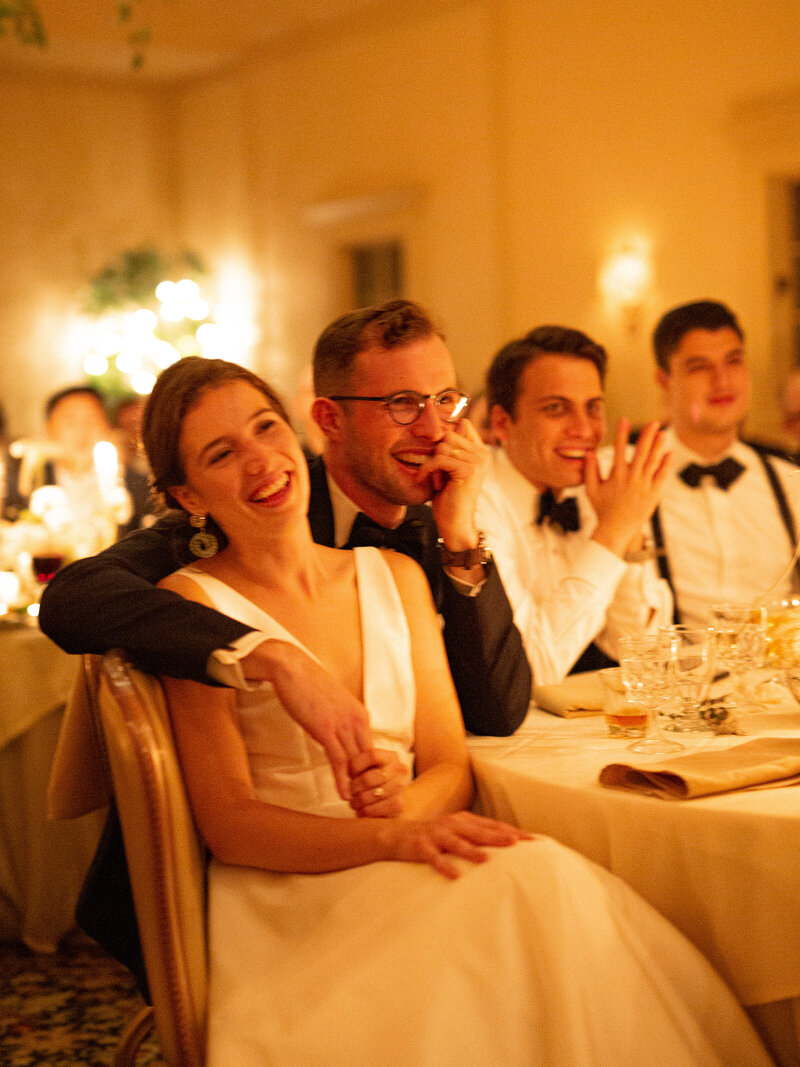 Bride and Groom laughing at dinner