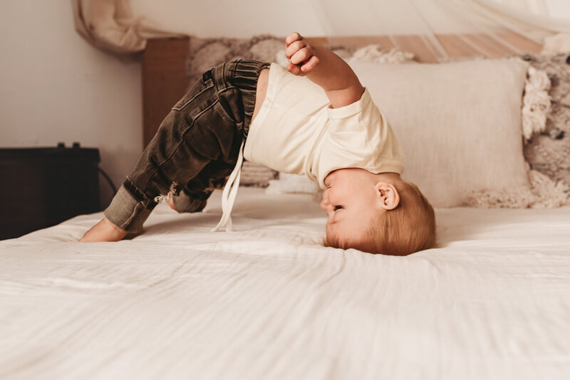 During his milestones session, a little guy shows off his goofy side while playing on the bed setup at the Nikii Pix Studios in Bismarck, ND. 